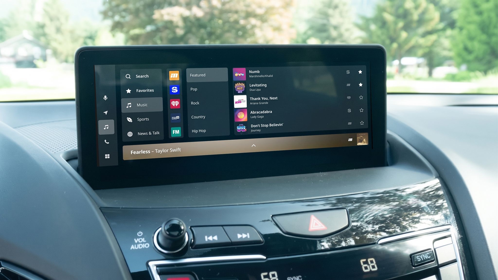 iM Media Hub's music view on an in-dash screen: stations, sources, and a live queue