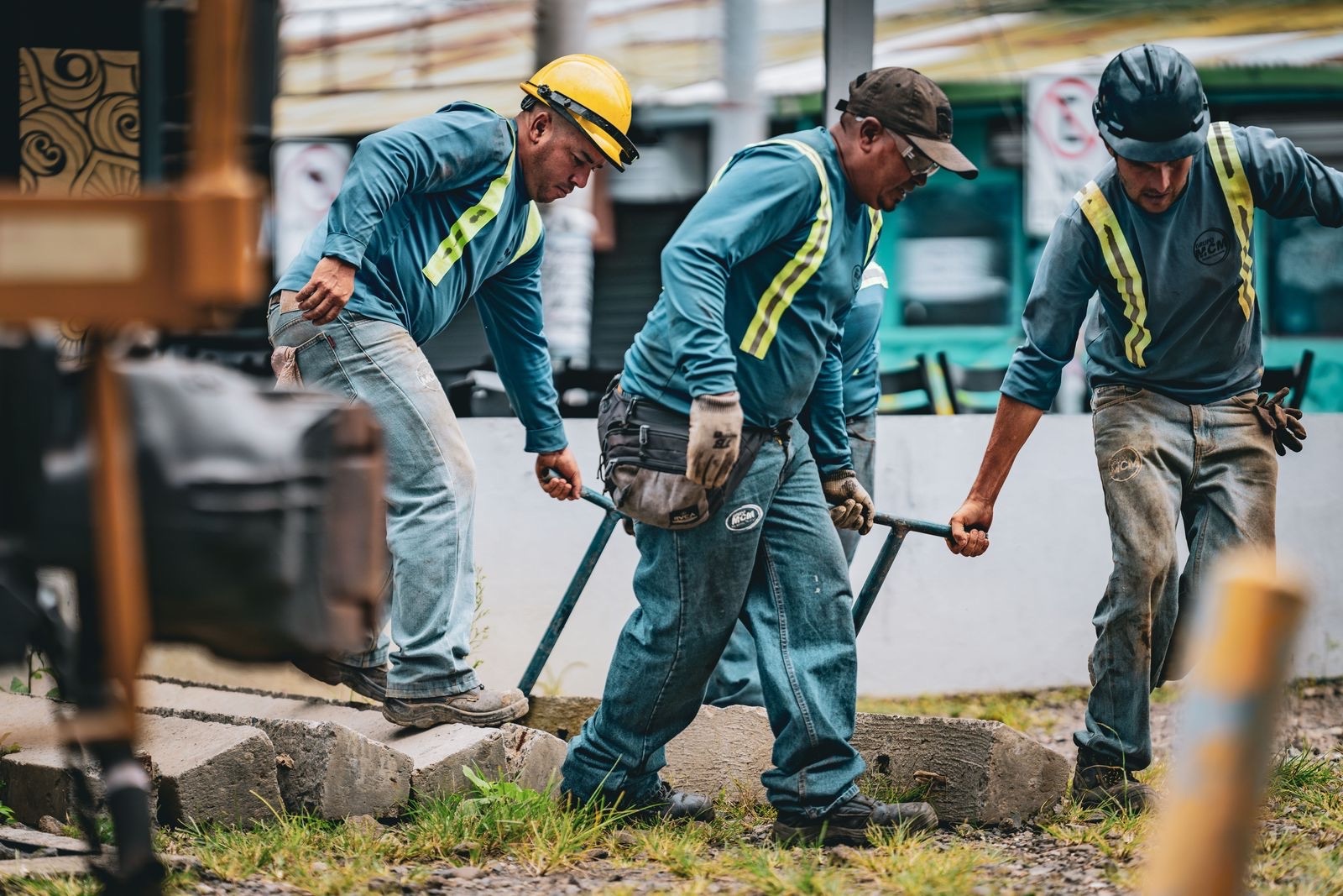 Frontline construction workers mid-shift on a street site in Latin America